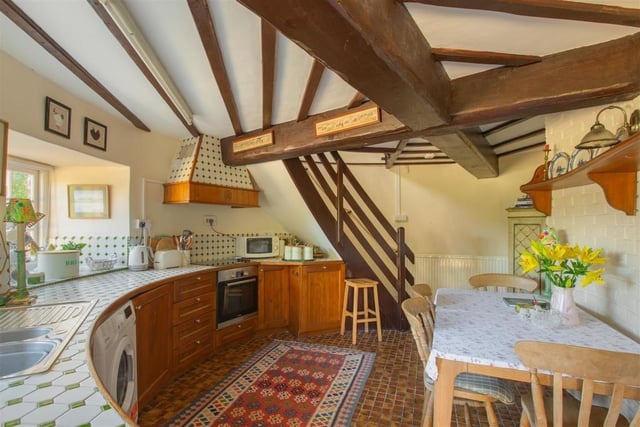 The ground floor is home to the cute kitchen, complete with a circular worktop and wooden beams.