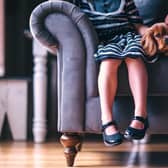 Children sitting on a sofa with a dog. (Picture: Pexels from Pixabay)