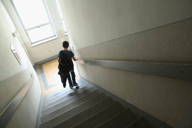 A 6th grade pupil walks down a stairwell. Photo by Sean Gallup/Getty Images
