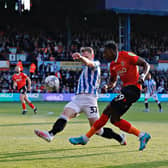 Amari'i Bell sends over a cross during Town's play-off semi-final with Huddersfield