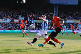 Amari'i Bell sends over a cross during Town's play-off semi-final with Huddersfield