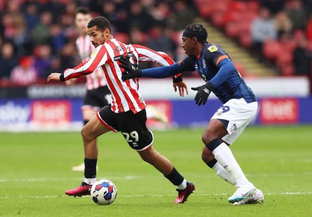 Amari'i Bell looks to put a challenge in against Sheffield United