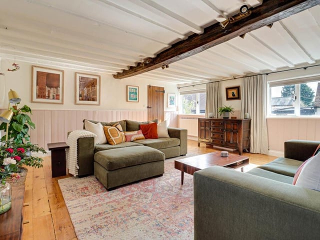 Despite having lower ceilings than most homes, the living room is light and airy - thanks to the quirky, original windows.