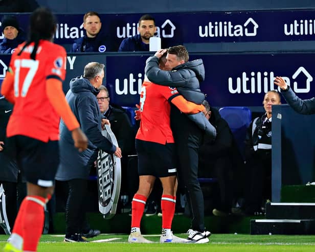 Luton boss Rob Edwards gives striker Carlton Morris a hug during Town's 4-0 win over Brighton - pic: Liam Smith