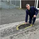 South West Bedfordshire MP next to a pothole. Picture: Andrew Selous