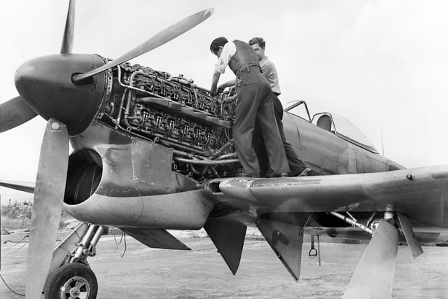 Men carrying out maintenance on a Napier engine installed on Typhoon plane in 1946