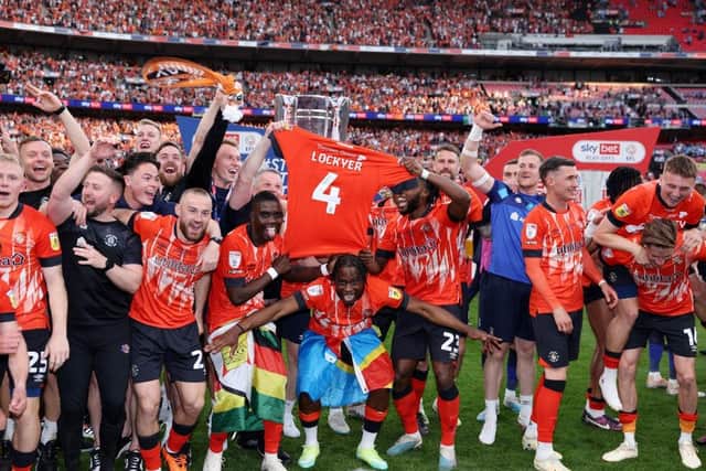 Luton's players hold up Tom Lockyer's shirt at Wembley