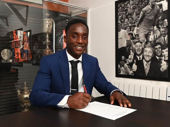 Daniel Idiakhoa puts pen to paper on his contract at Luton in the summer