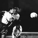Phil Gray goes up for a challenge with Arsenal's Lee Dixon during Town's last season in the top flight - pic: Hatters Heritage