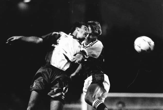 Phil Gray goes up for a challenge with Arsenal's Lee Dixon during Town's last season in the top flight - pic: Hatters Heritage