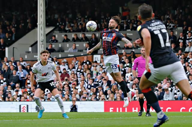 Henri Lansbury looks to win the ball against Fulham this evening