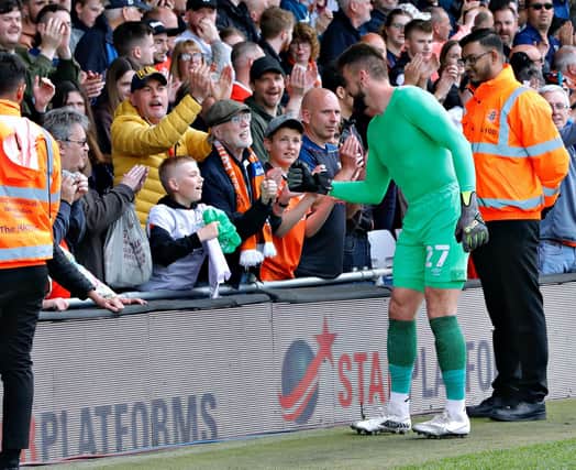 Matt Ingram fist bumps a Luton supporter after Town's 1-0 win over Reading
