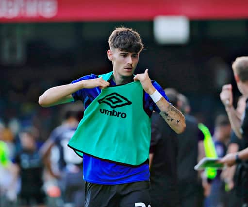 Town midfielder Elliot Thorpe gets ready to come on against Newport