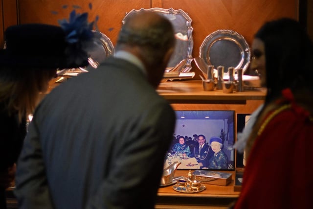 King Charles is shown a photograph of his late mother, Queen Elizabeth II, during his visit to Luton Town Hall (Photo by DANIEL LEAL/POOL/AFP via Getty Images)