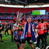 Alfie Doughty lifts the trophy at Wembley