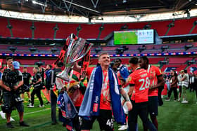 Alfie Doughty lifts the trophy at Wembley