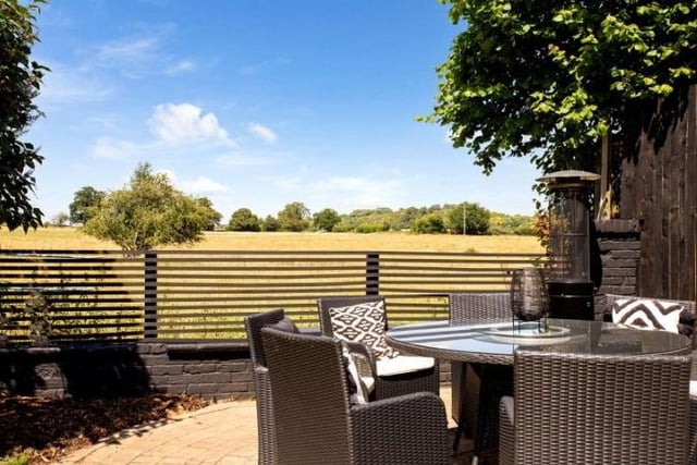 The spacious patio is perfectly designed for al fresco dining with views lovely across open countryside