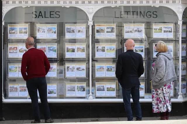 People looking at the window of an estate agent. Picture: Yui Mok/PA