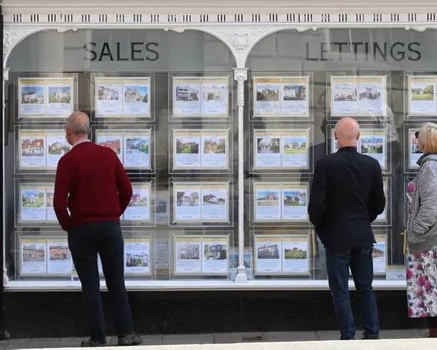 People looking at the window of an estate agent. Picture: Yui Mok/PA
