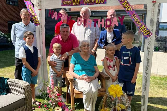 Nellie Phillips celebrating her 100th birthday with members of her family