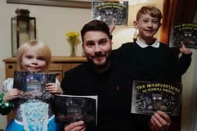 Jonathan Gadenne and his children with his two books