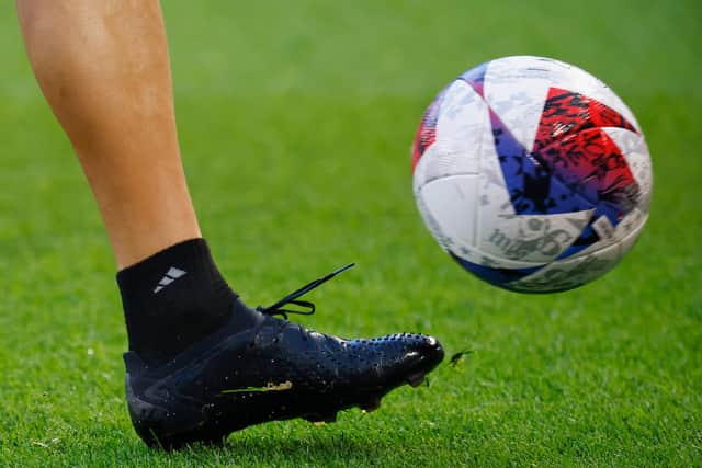 A close-up view of a football and cleats. (Photo by Bruce Bennett/Getty Images)