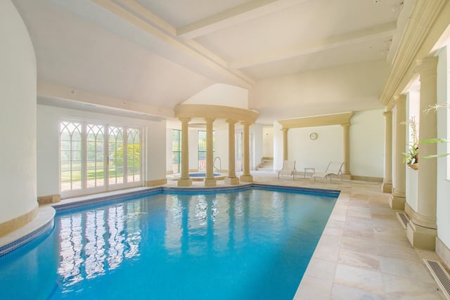 This Roman-style pool room has a jacuzzi and an adjoining sauna and changing room