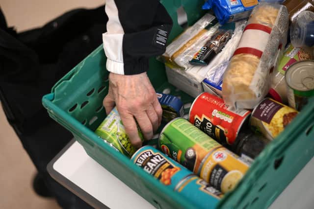 A member the public looks through food items inside a foodbank in Hackney, north-east London on October 31, 2022 (Photo by Daniel LEAL / AFP) (Photo by DANIEL LEAL/AFP via Getty Images)