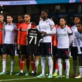 Luton and Bolton players pay their respects to Trotters supporters Iain Purslow who died recently - pic: Gareth Copley/Getty Images