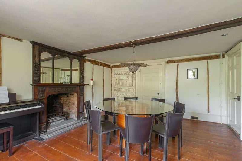 The house boasts over 4,200 sqft of living space, including this lovely dining area with a fireplace.