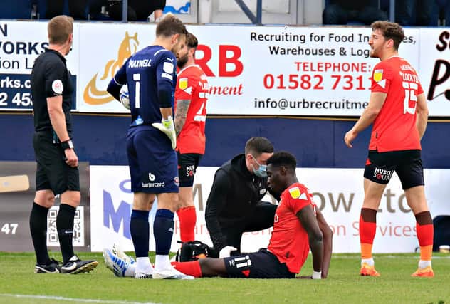 Elijah Adebayo receives treatment for his hamstring injury against Blackpool