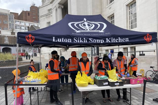 Volunteers set up the Sikh Soup Kitchen stall in readiness for the queues that will soon form