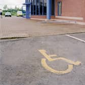Disabled priority parking space in car park. Photo by Jean-Francois Cardella/Construction Photography/Avalon/Getty Images