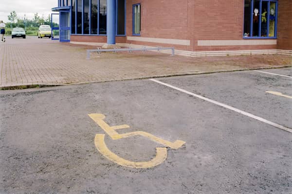 Disabled priority parking space in car park. Photo by Jean-Francois Cardella/Construction Photography/Avalon/Getty Images