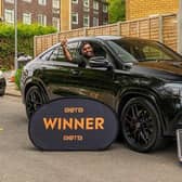 Luton student Vinod Kumar Emmadi with his winnings - a top-of-the-range Mercedes with £20,000 cash in the boot