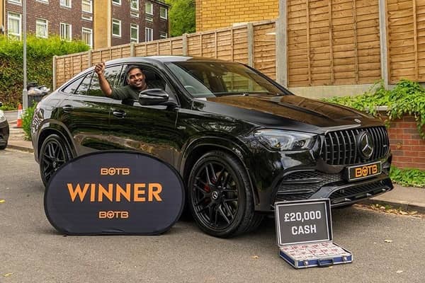 Luton student Vinod Kumar Emmadi with his winnings - a top-of-the-range Mercedes with £20,000 cash in the boot