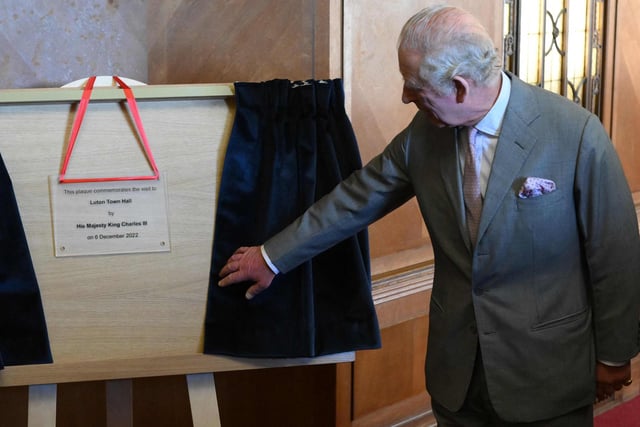 Britain's King Charles III unveils a plaque commemorating his visit to Luton Town Hall  (Photo by DANIEL LEAL/POOL/AFP via Getty Images)