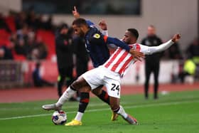 Carlton Morris is challenged during this evening's 2-0 defeat to Stoke