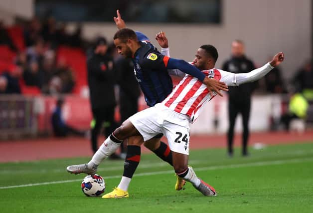 Carlton Morris is challenged during this evening's 2-0 defeat to Stoke