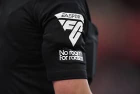 The officials wear a No room for racism patch at the City Ground on Saturday - pic: Tony Marshall/Getty Images