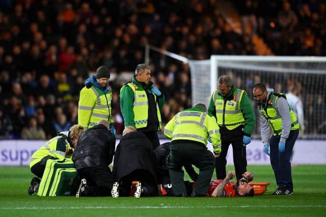 Sonny Bradley receives treatment before being stretchered off against Reading