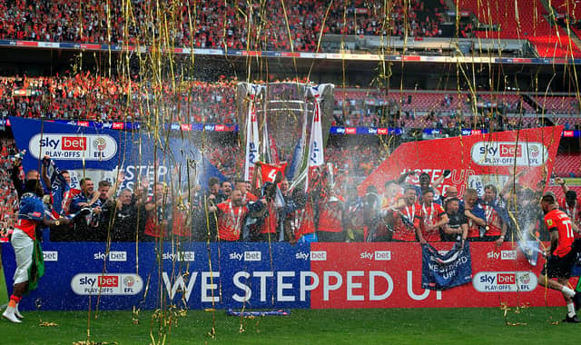 Luton's players celebrate winning the Championship play-off final at Wembley