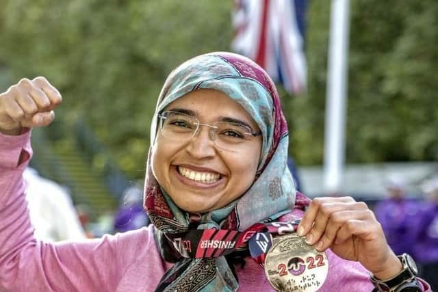 Naushin celebrating with a medal after finishing the London Marathon
