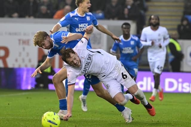 George Johnston gets stuck in against Peterborough United - pic: David Lowndes