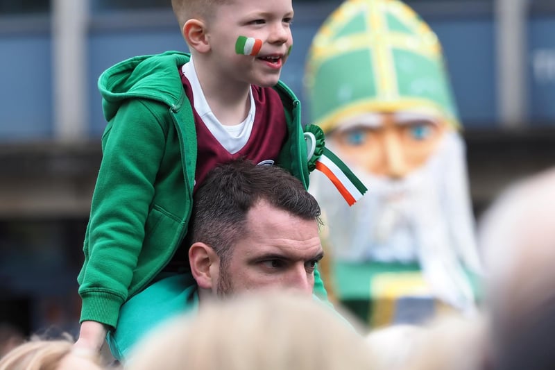 This little boy got on his father's shoulders for a better view of the action.