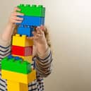 A child plays with plastic building blocks. Picture: Dominic Lipinski via PA Images