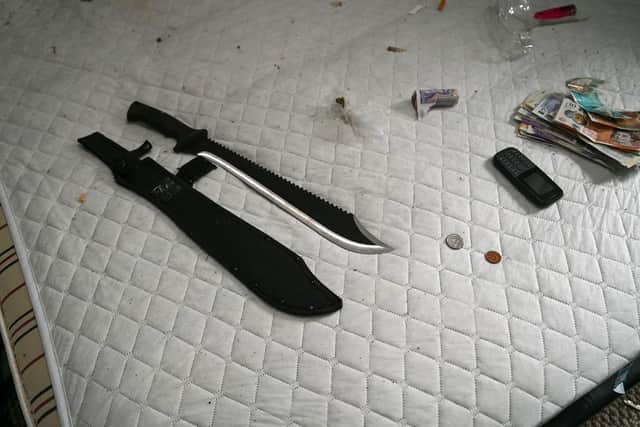 A knife and cash was seized during the raid on Tuesday