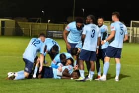 John Shamalo is mobbed by his team-mates after sealing AFC Dunstable's victory - pic: Angelcooperphotography