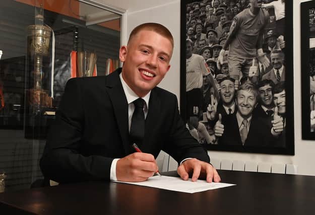 Tobias Braney signs his deal with the Hatters
