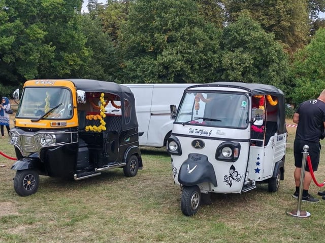 Two brightly decorated tuk-tuks that were used on the day for short rides.